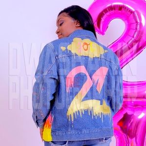 A custom painted 21 themed painted jacket with pink,gold,orange,and yellow.